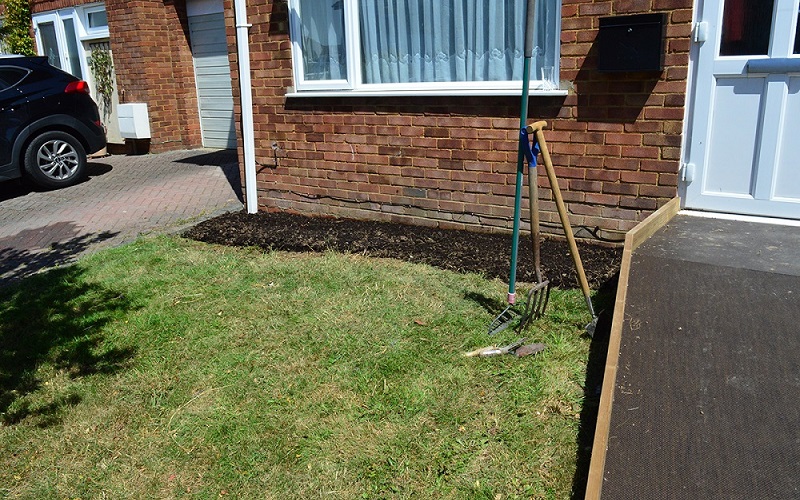 weeded flower bed in front garden
